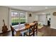 Bright dining room featuring a wooden table, large windows and wood floors at 5311 Larita Ln, Anderson, IN 46017
