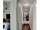 Arched hallway view looking to kitchen area featuring wood floors and neutral paint at 5311 Larita Ln, Anderson, IN 46017