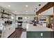 Bright kitchen features white cabinets, stainless appliances, large island, and stylish pendant lighting at 5311 Larita Ln, Anderson, IN 46017
