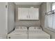 Bright laundry room with white washer and dryer, complemented by white cabinets for storage at 5311 Larita Ln, Anderson, IN 46017
