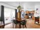 Bright dining area with a wooden table, modern chairs, and a sliding glass door leading to the deck at 5357 Collett E Dr, Camby, IN 46113