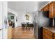 Open dining area features wood floors, modern lighting, and stainless steel appliances for a cozy and functional space at 5357 Collett E Dr, Camby, IN 46113