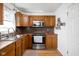 Cozy kitchen featuring stainless steel appliances, warm wood cabinets, and a mosaic backsplash at 5357 Collett E Dr, Camby, IN 46113