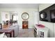Bright living room with a view into the dining area, a mounted TV, and a decorative mirror at 5357 Collett E Dr, Camby, IN 46113
