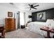Spacious main bedroom featuring a ceiling fan, plush carpeting, and a dark accent wall for a cozy retreat at 5357 Collett E Dr, Camby, IN 46113