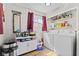Functional laundry area with washer, dryer, storage cabinets and shelving at 5427 E 19Th St, Indianapolis, IN 46218