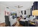 Cozy living room with hardwood floors, a ceiling fan, and comfortable seating at 5427 E 19Th St, Indianapolis, IN 46218