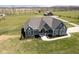 Stunning aerial view of a modern home with a well-manicured lawn and large barn on expansive acreage at 5679 S 675 W, New Palestine, IN 46163