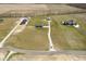 Spacious property showcasing a house with long driveway, additional buildings, and vast green lawn at 5679 S 675 W, New Palestine, IN 46163