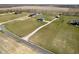 Expansive aerial view of a well-maintained property with a large green lawn, buildings and a long driveway at 5679 S 675 W, New Palestine, IN 46163