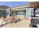 Relaxing backyard patio with dining set, umbrella, and covered porch, perfect for outdoor entertaining and lounging at 5679 S 675 W, New Palestine, IN 46163
