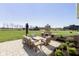 Inviting backyard patio with stone fireplace, comfortable seating, and views of the expansive lawn and barn at 5679 S 675 W, New Palestine, IN 46163