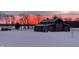 Barn with modern architecture silhouetted against colorful sunset skies, exemplifying rural elegance and peaceful charm at 5679 S 675 W, New Palestine, IN 46163