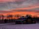 Modern barn with striking architecture silhouetted against colorful sunset skies, exemplifying rural elegance and peaceful charm at 5679 S 675 W, New Palestine, IN 46163