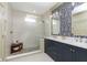 Bathroom featuring double vanity sinks, a tile shower with glass door, and stylish wallpaper at 5679 S 675 W, New Palestine, IN 46163