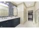 Bathroom with double vanity, modern fixtures, a stylish mirror, and decorative wallpaper at 5679 S 675 W, New Palestine, IN 46163