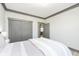 Comfortable bedroom featuring a gray accent wall, closet, and stylish furnishings at 5679 S 675 W, New Palestine, IN 46163