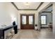 Elegant foyer with hardwood floors, stylish lighting, and a view into a bright, welcoming office at 5679 S 675 W, New Palestine, IN 46163