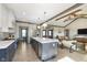 Spacious kitchen with a large center island, stainless steel appliances, and an open layout to the living room at 5679 S 675 W, New Palestine, IN 46163