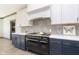 Gourmet kitchen featuring a professional range, custom cabinetry, and stylish tile backsplash at 5679 S 675 W, New Palestine, IN 46163