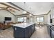 Bright and airy kitchen featuring a large island, open to the living and dining areas at 5679 S 675 W, New Palestine, IN 46163