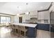 Well-lit kitchen island with bar seating, ample counter space, and stainless steel appliances at 5679 S 675 W, New Palestine, IN 46163