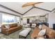 Open-concept living room with a kitchen view, featuring modern decor and ample natural light at 5679 S 675 W, New Palestine, IN 46163