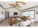 Spacious living room featuring high ceilings, exposed beams, and stylish leather furniture at 5679 S 675 W, New Palestine, IN 46163