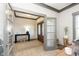 Home office view showcasing the entry way to the foyer and a well-lit, functional workspace at 5679 S 675 W, New Palestine, IN 46163