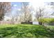 Large backyard with green grass and chain link and wood fencing, perfect for outdoor activities at 5735 Brouse Ave, Indianapolis, IN 46220