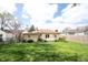 Expansive backyard featuring a wooden deck and lush green grass at 5735 Brouse Ave, Indianapolis, IN 46220