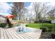 Backyard featuring a deck with lounge seating and lush green grass at 5735 Brouse Ave, Indianapolis, IN 46220