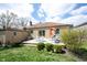 Backyard featuring a charming deck with seating and lush landscaping at 5735 Brouse Ave, Indianapolis, IN 46220