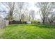Expansive backyard featuring lush green grass, a shed, and a combination of wooden and chain-link fencing at 5735 Brouse Ave, Indianapolis, IN 46220