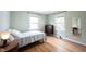 Bright bedroom featuring hardwood floors and natural light from two windows at 5735 Brouse Ave, Indianapolis, IN 46220