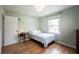 Cozy bedroom with hardwood floors, a full sized bed, and a window view at 5735 Brouse Ave, Indianapolis, IN 46220