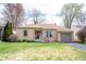 Charming ranch-style home with a well-maintained lawn, an attached garage, and inviting curb appeal at 5735 Brouse Ave, Indianapolis, IN 46220