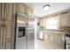 Bright kitchen features granite countertops, stainless steel appliances, ample cabinetry, and a light-filled window at 5735 Brouse Ave, Indianapolis, IN 46220