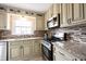 Bright kitchen features granite countertops, mosaic backsplash, stainless steel appliances, and ample cabinetry at 5735 Brouse Ave, Indianapolis, IN 46220
