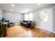 Inviting living room with hardwood floors, neutral walls, a front door, and a window providing ample light at 5735 Brouse Ave, Indianapolis, IN 46220