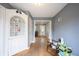 Charming living room with hardwood floors and white trim, offering a glimpse of the front door and other rooms at 5735 Brouse Ave, Indianapolis, IN 46220
