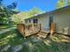 The backyard view features a charming wooden deck, great for outdoor relaxation and entertaining at 5820 Bonnie Brae St, Indianapolis, IN 46228