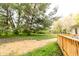 Landscaped back yard featuring a wooden deck and mature trees, ideal for outdoor relaxation and entertaining at 5820 Bonnie Brae St, Indianapolis, IN 46228