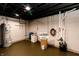 The basement features a modern laundry area, water heater, and painted concrete walls and floors at 5820 Bonnie Brae St, Indianapolis, IN 46228