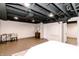 Spacious finished basement with painted ceiling, luxury vinyl floors, and stylish decor at 5820 Bonnie Brae St, Indianapolis, IN 46228