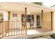 Cozy front porch with railing, seating, and a view of the yard at 5820 Bonnie Brae St, Indianapolis, IN 46228
