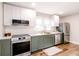 Modern kitchen featuring stainless steel appliances, white countertops, and two-tone cabinets at 5820 Bonnie Brae St, Indianapolis, IN 46228