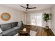 Living room featuring a gray sofa, hardwood floors, ceiling fan and sliding door to the deck at 5820 Bonnie Brae St, Indianapolis, IN 46228