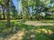 An idyllic backyard with mature trees creating a serene and shaded outdoor space at 5820 Bonnie Brae St, Indianapolis, IN 46228
