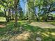 An idyllic backyard with mature trees creating a serene and shaded outdoor space at 5820 Bonnie Brae St, Indianapolis, IN 46228